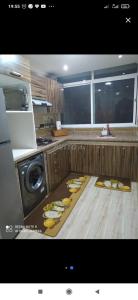 a kitchen with a table with plates of food on the floor at العرفان 3 طريق أشقار in Tangier