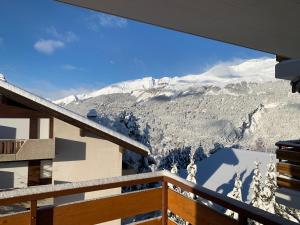 a view of the mountains from the balcony of a house at La Jacinthe de Crans in Crans-Montana