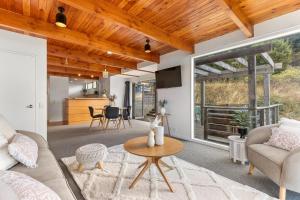 a living room with a couch and a table at Spacious relaxing home in Queenstown