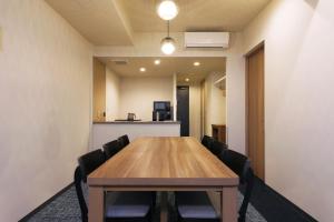 a conference room with a wooden table and chairs at stayme THE HOTEL Ueno Ekimae in Tokyo