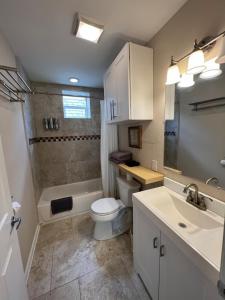 a bathroom with a toilet and a sink and a shower at Tise Plaza Condos in New Orleans