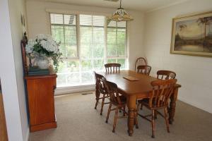 a dining room with a wooden table and chairs at Mon Desir in Chum Creek
