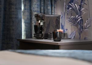 a coffee machine sitting on a counter with two cups at Home at 2 Tancred Road Anfield in Liverpool