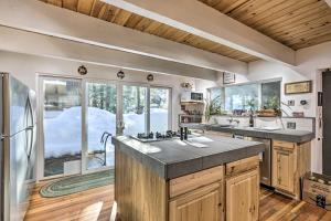 a kitchen with two sinks and a large window at Quintessential Tahoe Cabin with Private Hot Tub in South Lake Tahoe