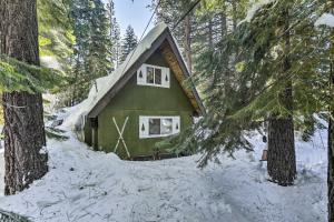 a small house in the snow in the woods at Quintessential Tahoe Cabin with Private Hot Tub in South Lake Tahoe