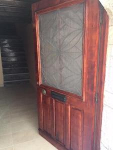 a wooden door with a glass window on it at The Knight and the Pomegranate - Luxury Medieval Villa in Rhodes Town