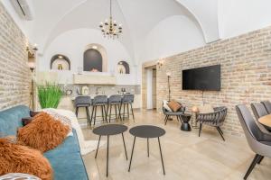 a living room with a blue couch and chairs at Nina Luxury Apartment in Jerusalem