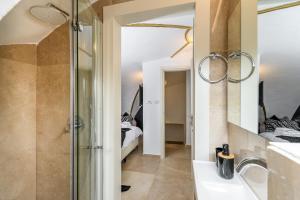 a bathroom with a shower and a sink and a mirror at Nina Luxury Apartment in Jerusalem +25 photos