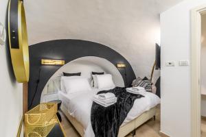 a bedroom with two beds with white pillows at Nina Luxury Apartment in Jerusalem