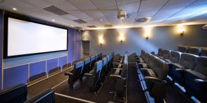 an empty auditorium with a large screen in a theater at Crieff Hydro Self Catering in Crieff