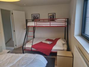 a bedroom with two bunk beds and a bed at Vakantiewoning Bisonder in Bilzen