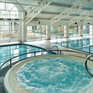 a large swimming pool with a hot tub in a building at Crieff Hydro Self Catering in Crieff