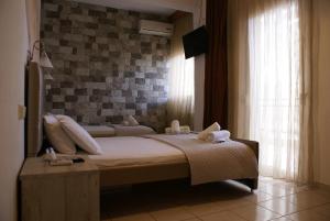 A bed or beds in a room at VARBENIS STUDIOS