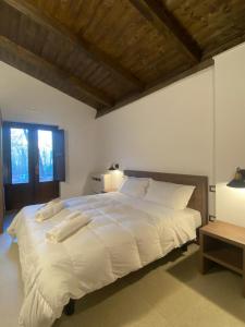 a large white bed in a bedroom with a window at Elda Hotel in Vico del Gargano