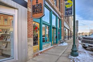 a street sign on a pole in front of a store at Downtown Cherokee Iowa Vacation Rental in Cherokee