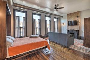 1 dormitorio con cama, sofá y chimenea en Downtown Cherokee Iowa Vacation Rental, en Cherokee