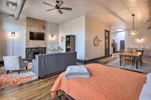 a living room with a bed and a dining room at Downtown Cherokee Iowa Vacation Rental in Cherokee