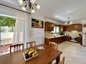a kitchen with a table with a bowl of fruit on it at Villa Atlantis in Katelios