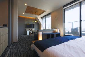 a bedroom with a bed and a desk with a television at stayme THE HOTEL Asakusa Riverside in Tokyo