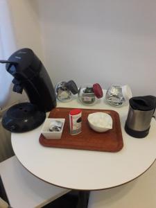 a table with a black mixer and a tray of food at Studio confort Verviers in Verviers