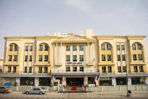a large building with cars parked in front of it at The Castle Hotel in Amman