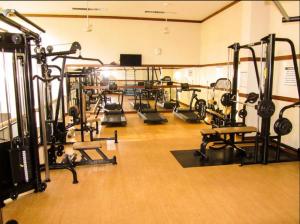 a gym with a lot of treadmills and machines at Apto de frente para a praia com vista pra lagoa in Rio de Janeiro