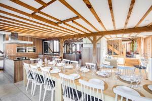 a dining room and kitchen with a table and chairs at Luxury, countryside barn conversion with Hot tub in Kent