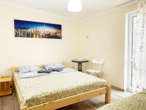 1 dormitorio con 1 cama y una pintura en la pared en Хостел "На Янгеля" с парковкой WIFI, en Vínnytsia