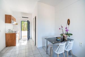 a kitchen and dining room with a table and chairs at Maria's Studios in Frangokastello