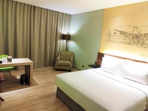 Ένα ή περισσότερα κρεβάτια σε δωμάτιο στο AONE Hotel