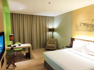 Ένα ή περισσότερα κρεβάτια σε δωμάτιο στο AONE Hotel