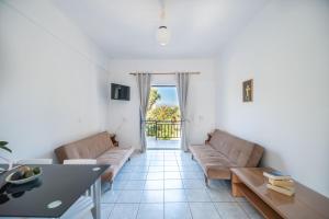 a living room with a couch and a table at Maria's Studios in Frangokastello