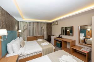 Postel nebo postele na pokoji v ubytování Hotel Devman