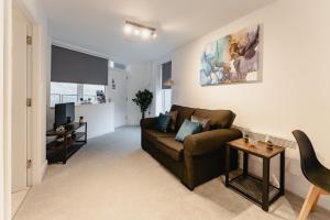 a living room with a couch and a table at Prescott Court Serviced Apartments in Halifax