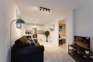 a living room with a couch and a television at Prescott Court Serviced Apartments in Halifax