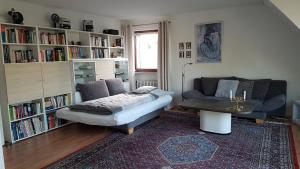 a living room with a couch and a chair at Ferienwohnung GOMO in Stockelsdorf