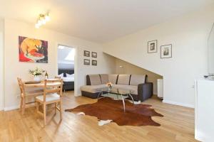 a living room with a couch and a table at Villa Livia Whg 05 in Ahlbeck