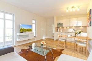 a living room with a table and a kitchen at Villa Livia Whg 05 in Ahlbeck