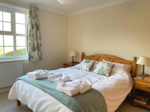 a bedroom with a bed with towels on it at Spacious 4 Bedroom House with Garden and Parking in Ecclesall