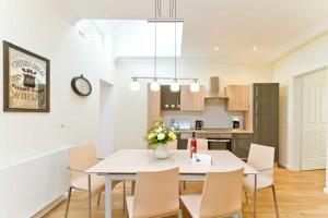 a kitchen and dining room with a white table and chairs at Villa Livia Whg 02 in Ahlbeck +20 photos