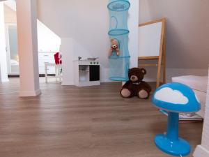 una habitación con un osito de peluche sentado en el suelo en Villa Malve Whg 10, en Bansin 20 fotos más
