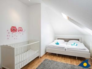 Postel nebo postele na pokoji v ubytování Villa Maria Gabriele Whg 13 + 8 fotografií
