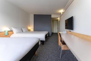 Кровать или кровати в номере ibis Paris Pantin Eglise +20 фотографий