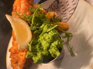 a plate of food with a spoon of guacamole at Red Lion Coaching Inn in Ellesmere +27 photos