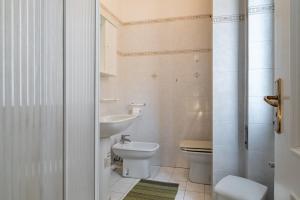 a bathroom with a toilet and a sink at Rivierarent Elisa 100 metri dal mare in Finale Ligure +15 photos