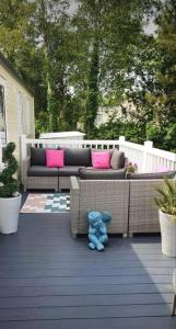 a blue teddy bear sitting on a patio at Susie's Beautiful Caravan near the sea in Pwllheli