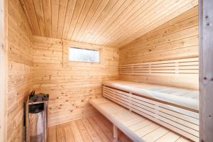 a wooden sauna with a bench and a window at Mobilheim am Murner See - private Sauna + privater Badezuber in Wackersdorf +28 photos