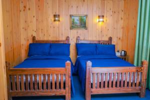 Postel nebo postele na pokoji v ubytování Blue Moon Residency
