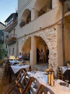 a restaurant with tables and chairs in front of a building at Slow holidays in Calabria tradizioni eno-gastonomia tra borgo e mare in Badolato