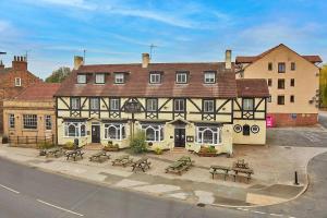 a large building with picnic tables in front of it at Finest Retreats - The Bank House in Boroughbridge